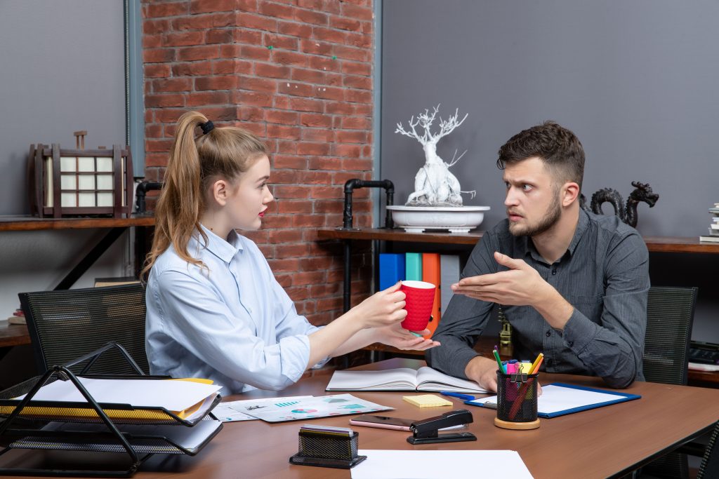 Business partners discussing workplace conflict during an office meeting